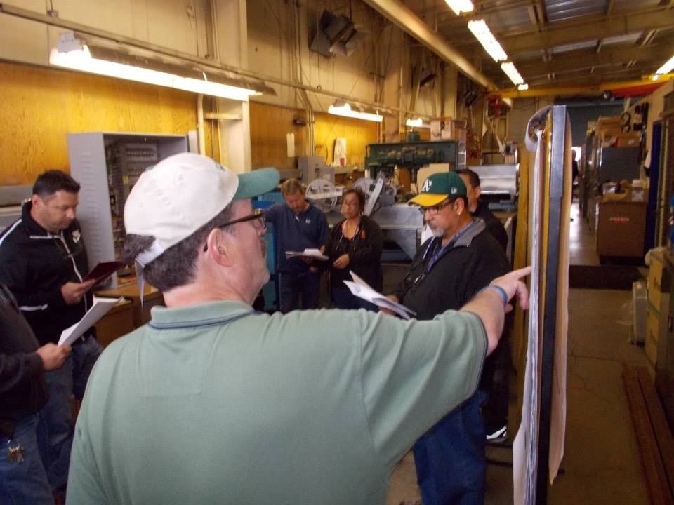 Instructor pointing out something on a flipchart to trainees