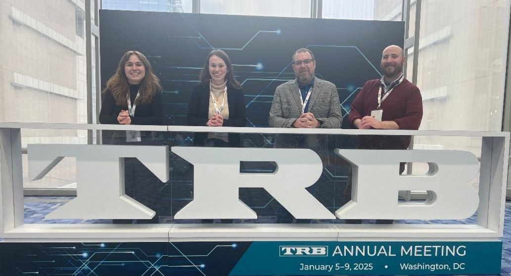4 ITLC team members posing at a conference