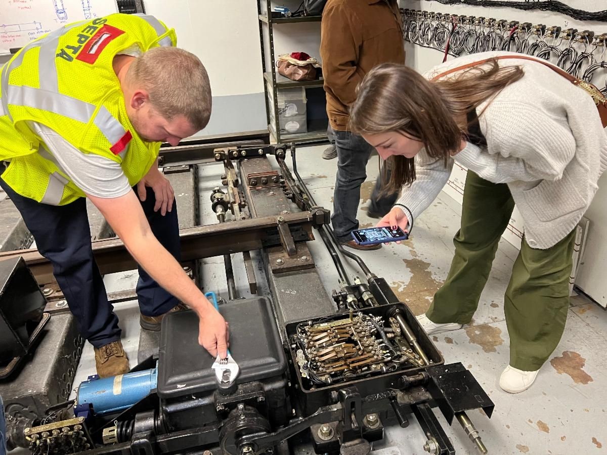 Transit worker showing someone a toolbox