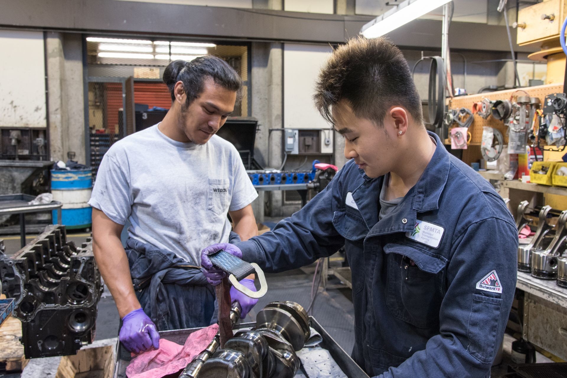 Two workers looking at machinery