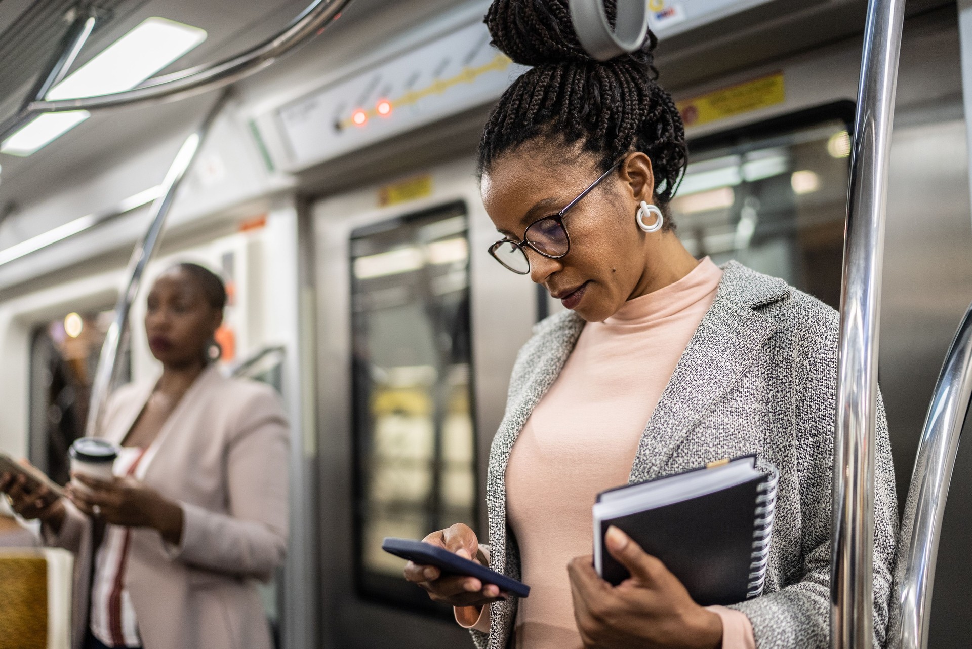 Mature woman using the mobile phone in the subway train
